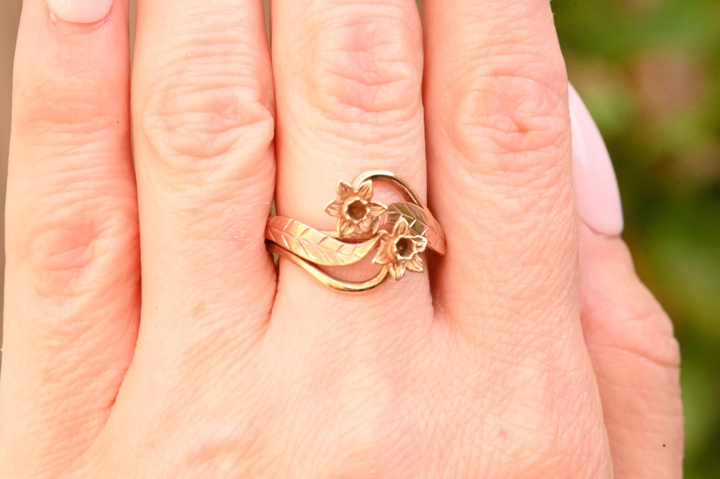 shown for scale- ring on finger. clogau jewellery. gold ring. daffodil. flower ring.