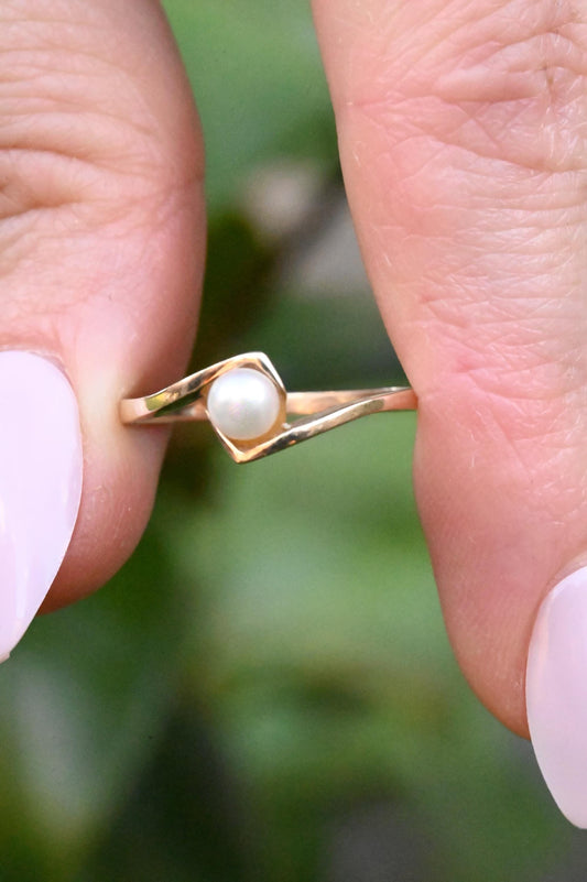 ring held in fingers - pretty white pearl vintage
