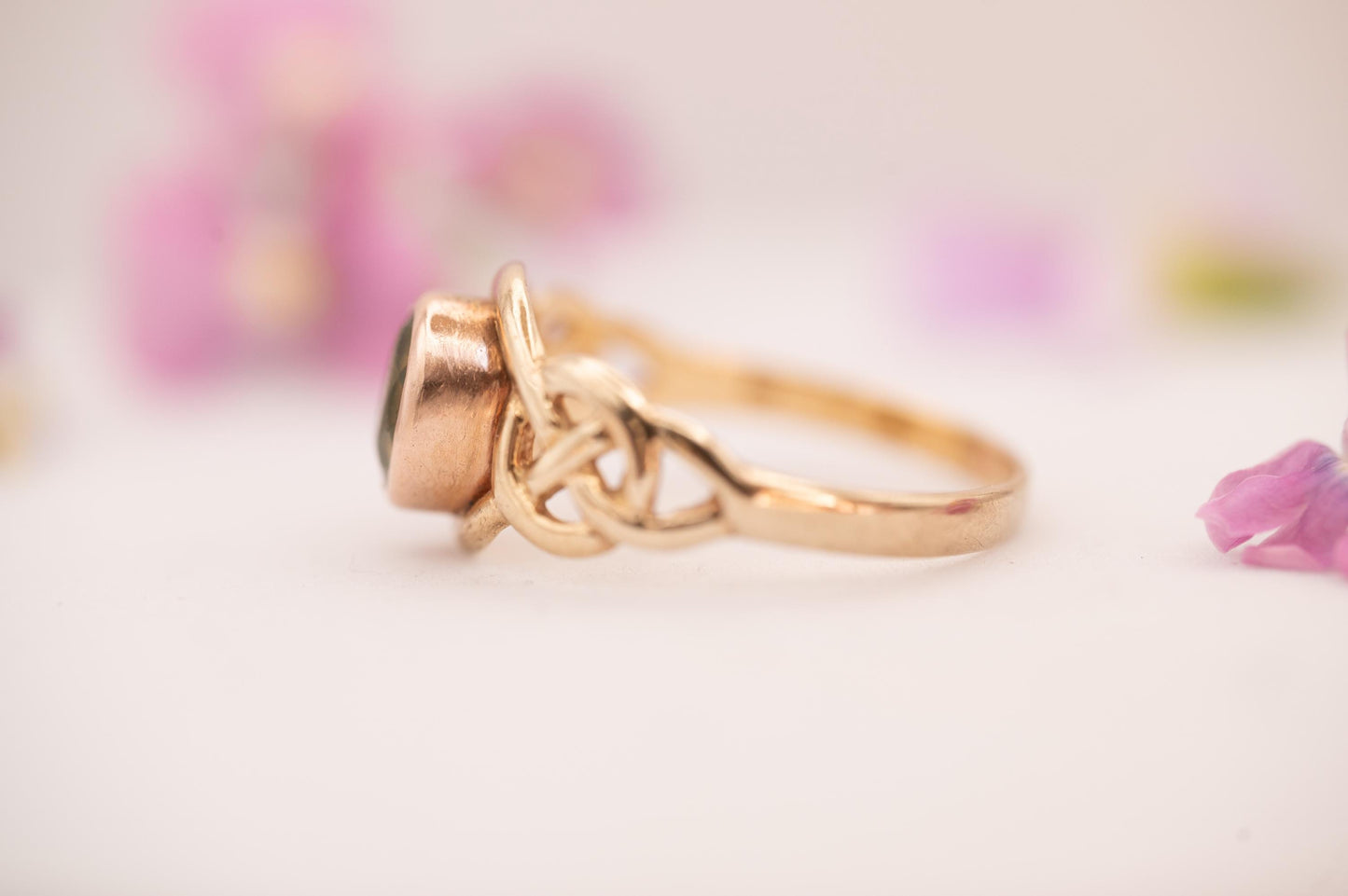 pretty peridot on side showing Celtic weave in 9ct and rose gold from Clogau official Welsh gold.