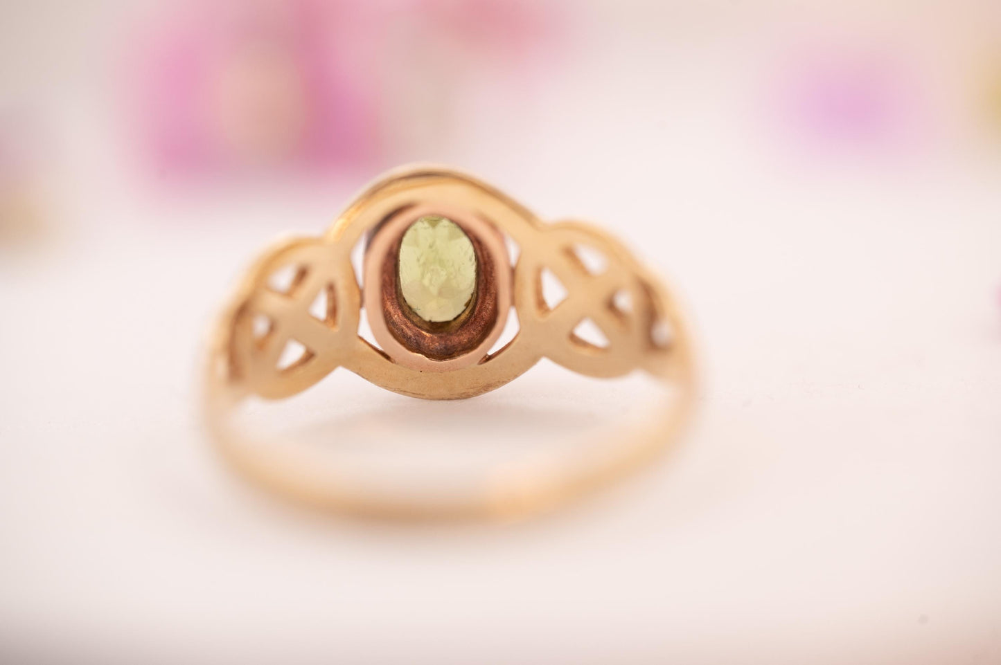 pretty peridot showing Celtic weave in 9ct and rose gold from Clogau official Welsh gold, back of stone shown - clear and bright real stone.