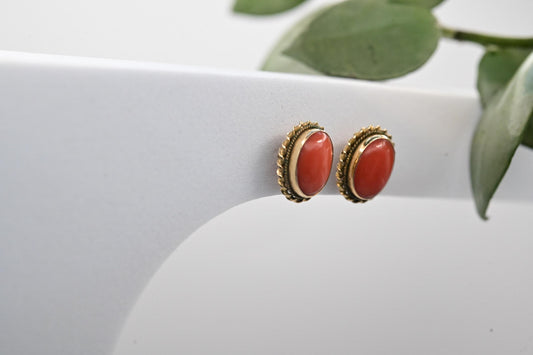 medium size stud earrings with vibrant coral stone set in Italian 18ct yellow gold - a perfect 1970s vintage pair of earrings shown against a white backdrop.