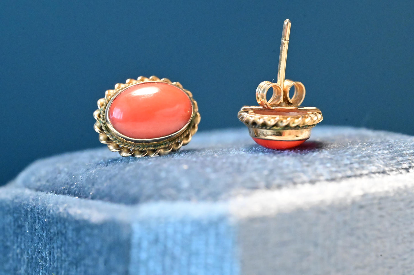 coral earrings shown clearly - a perfect coral colour rich and smooth with no imperfections. beautiful oval shape and set in Italian solid 18ct yellow gold. a glamorous addition to any jewellery box.