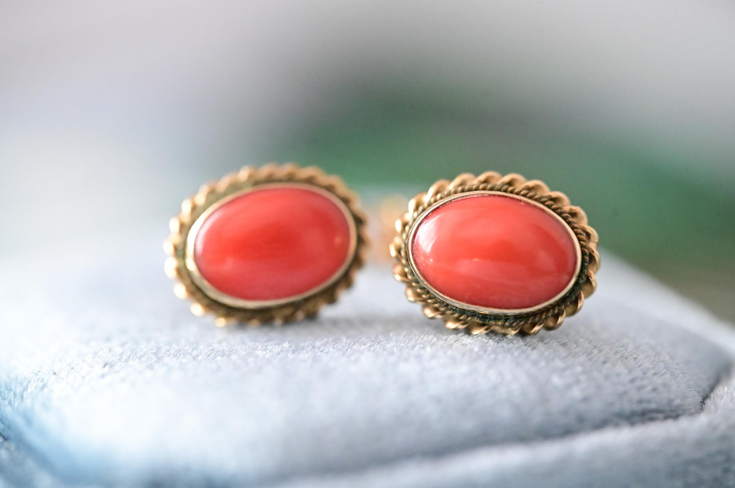coral shown clearly - a perfect coral colour rich and smooth with no imperfections. beautiful oval shape and set in Italian solid 18ct yellow gold. a glamorous addition to any jewellery box.