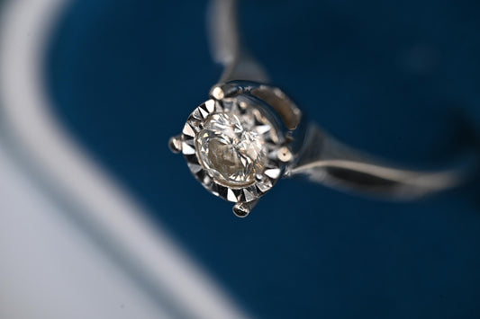 Pretty and dainty white gold solitaire Ring set in 9 carat white gold