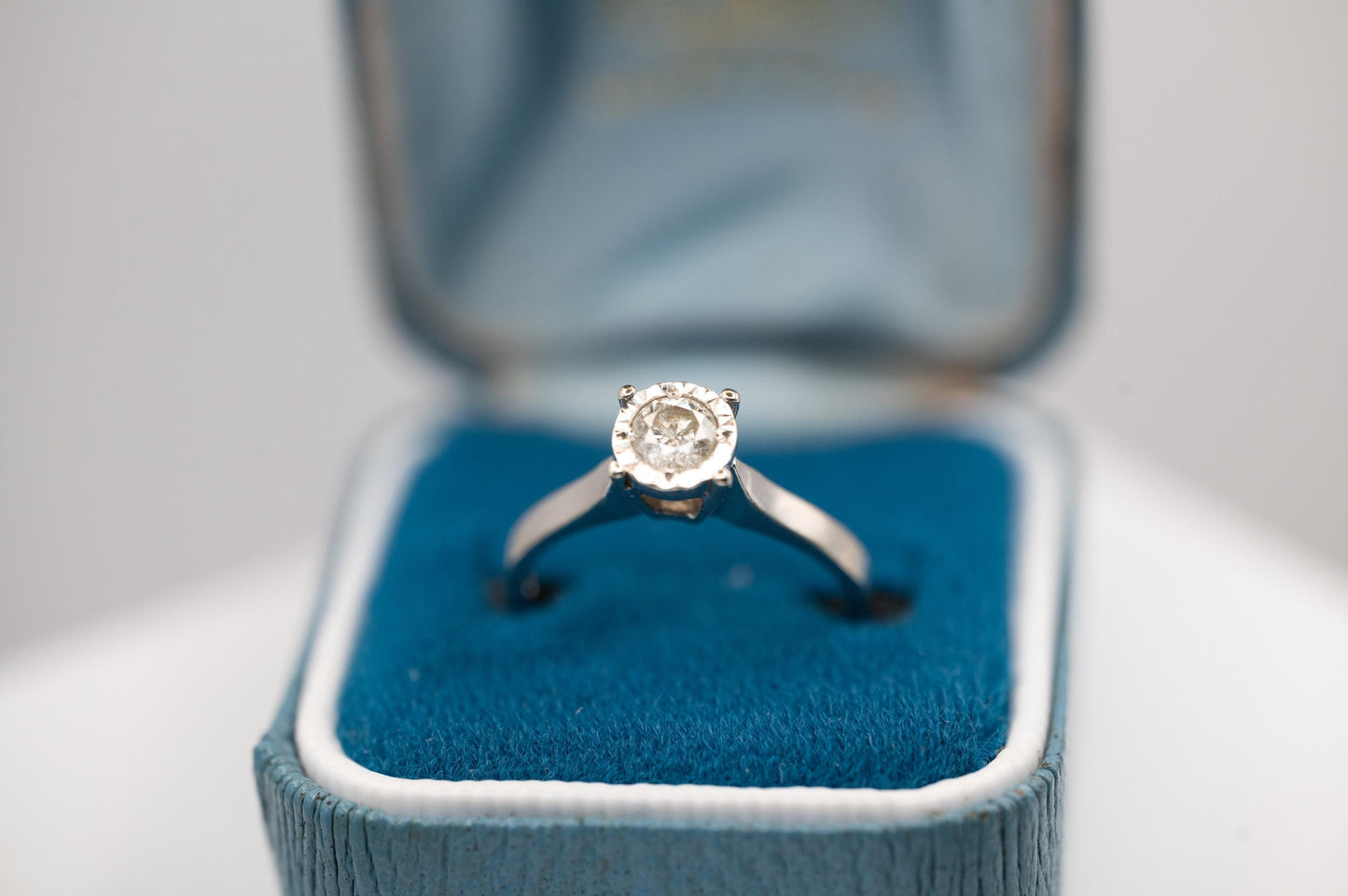a beautiful vintage timeless and elegant solitaire Ring set with 0.25 carat diamond with a lovely halo of etched diamond cut detailing around the diamond, a lovely 70s Solitaire diamond ring