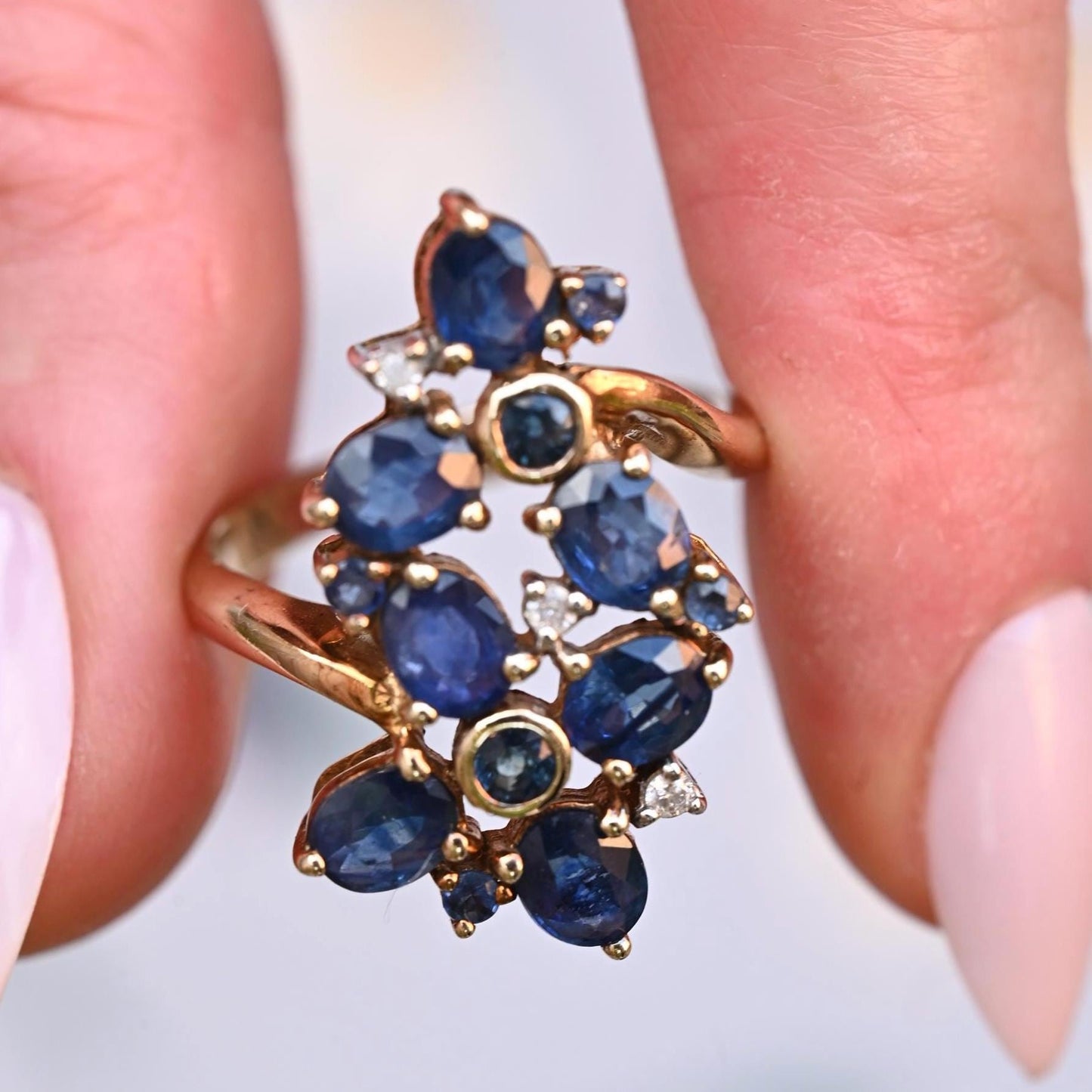 shown in fingers, quite a large ring making this a perfect dress ring. 9ct gold with sapphires