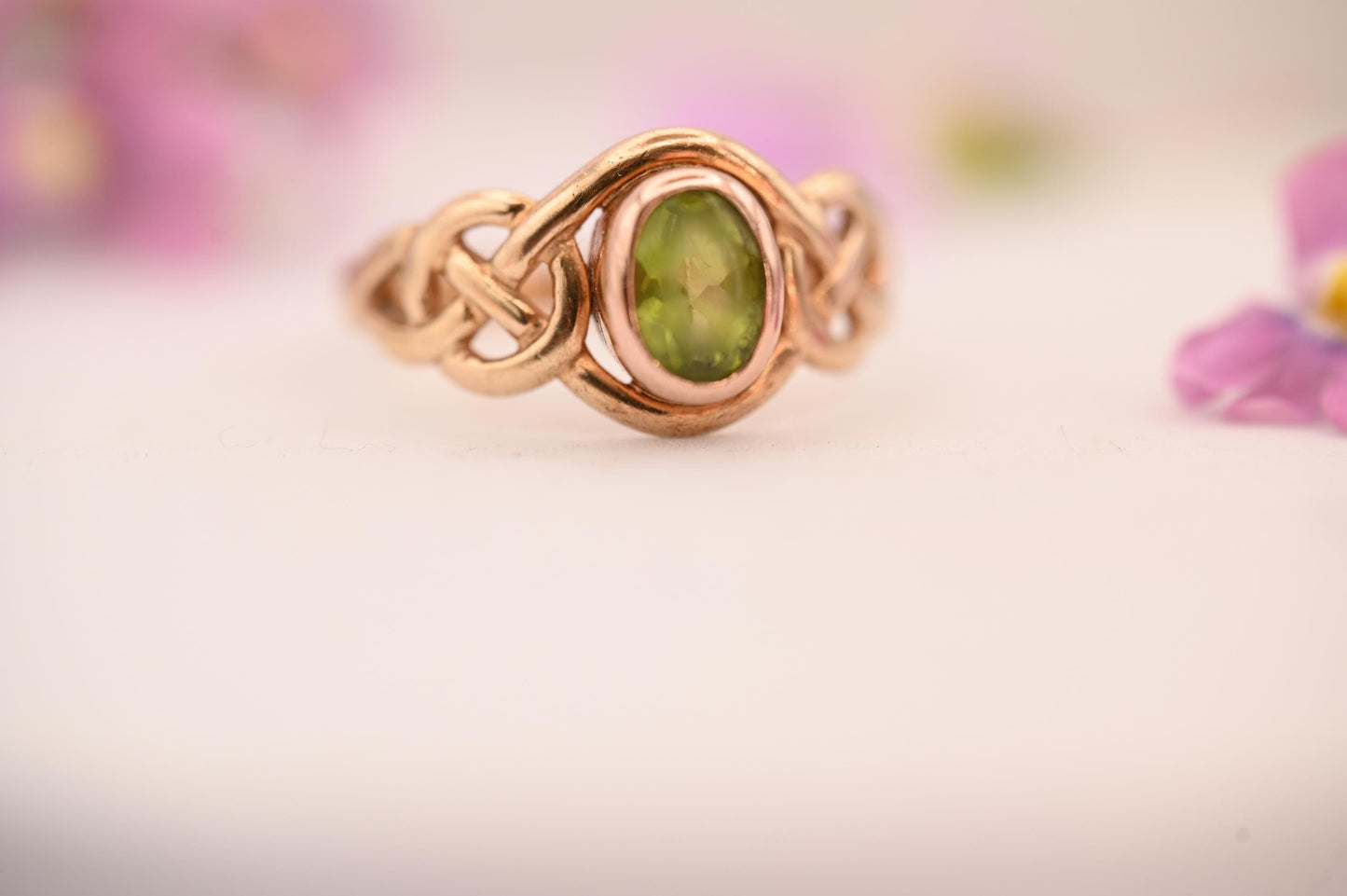real peridot ring shown at angle - very clear view of front and oval stone.