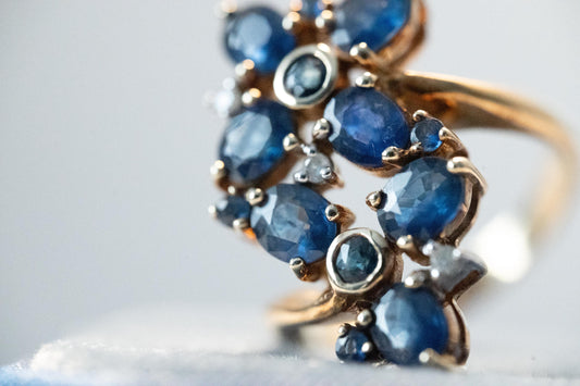 elegant style ring with natural sapphires to form petal design and CZ for added sparkle. Fully Assayed in Birmingham from 1990 Circa