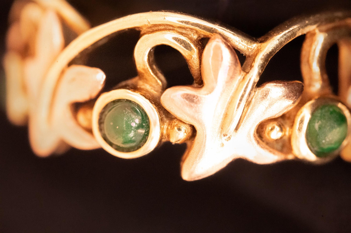 close up- ring- perfect condition - intricate detailing - leaf detailing -Beautiful- Vintage- Clogau- 9ct Yellow and Rose Gold- Lady-of-Caerphilly- Leaf Emerald- Ring-floral pattern- with small green emeralds - rare - Welsh gold - collectible - limited edition.