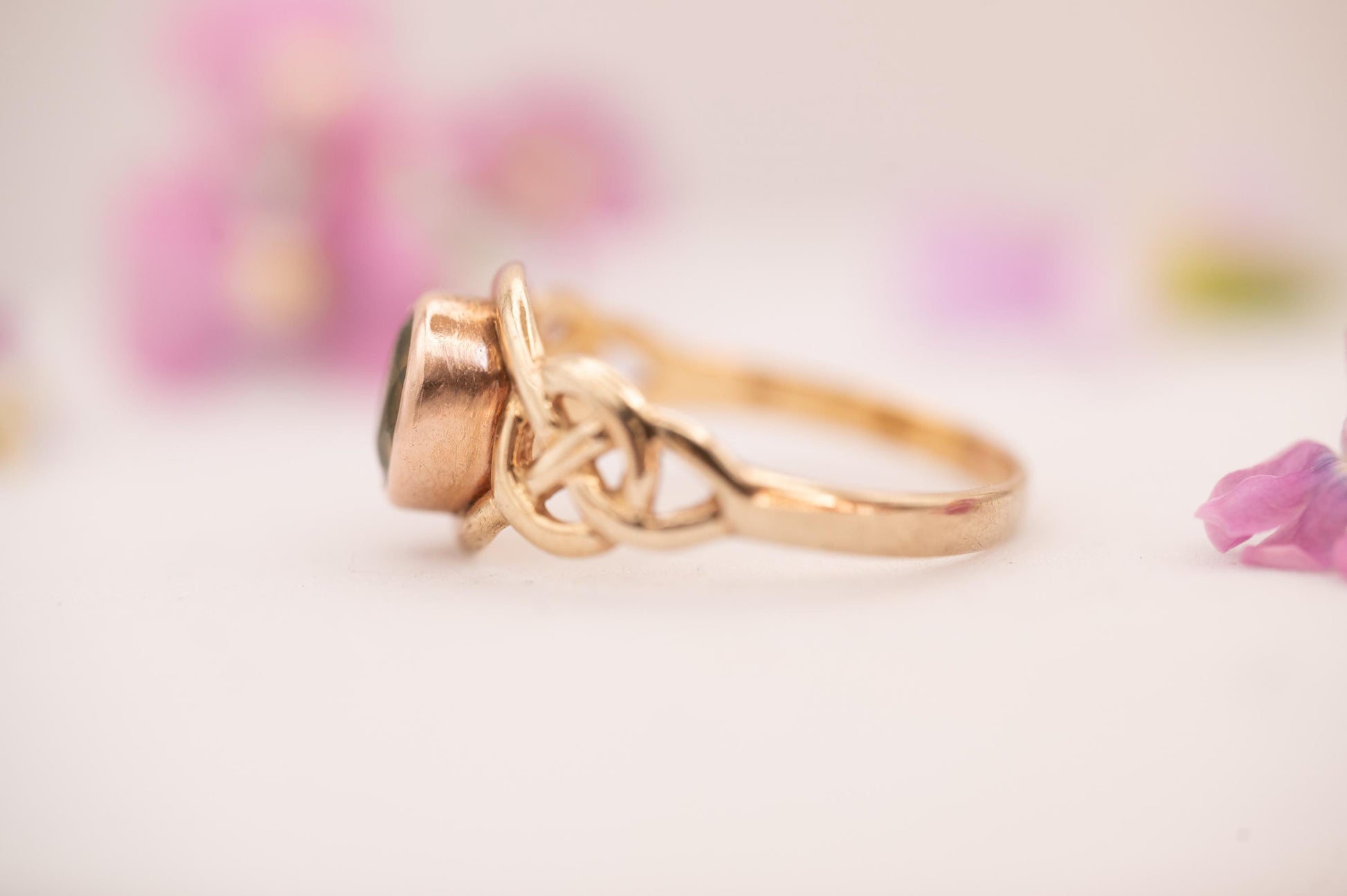 pretty peridot on side showing Celtic weave in 9ct and rose gold from Clogau official Welsh gold.