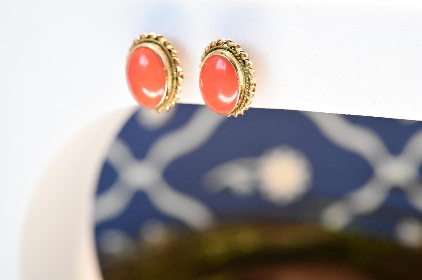 18ct yellow gold intricate vintage earrings with natural coral stone in an oval shape.