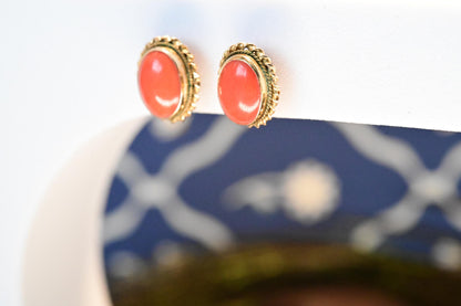 18ct yellow gold intricate vintage earrings with natural coral stone in an oval shape.