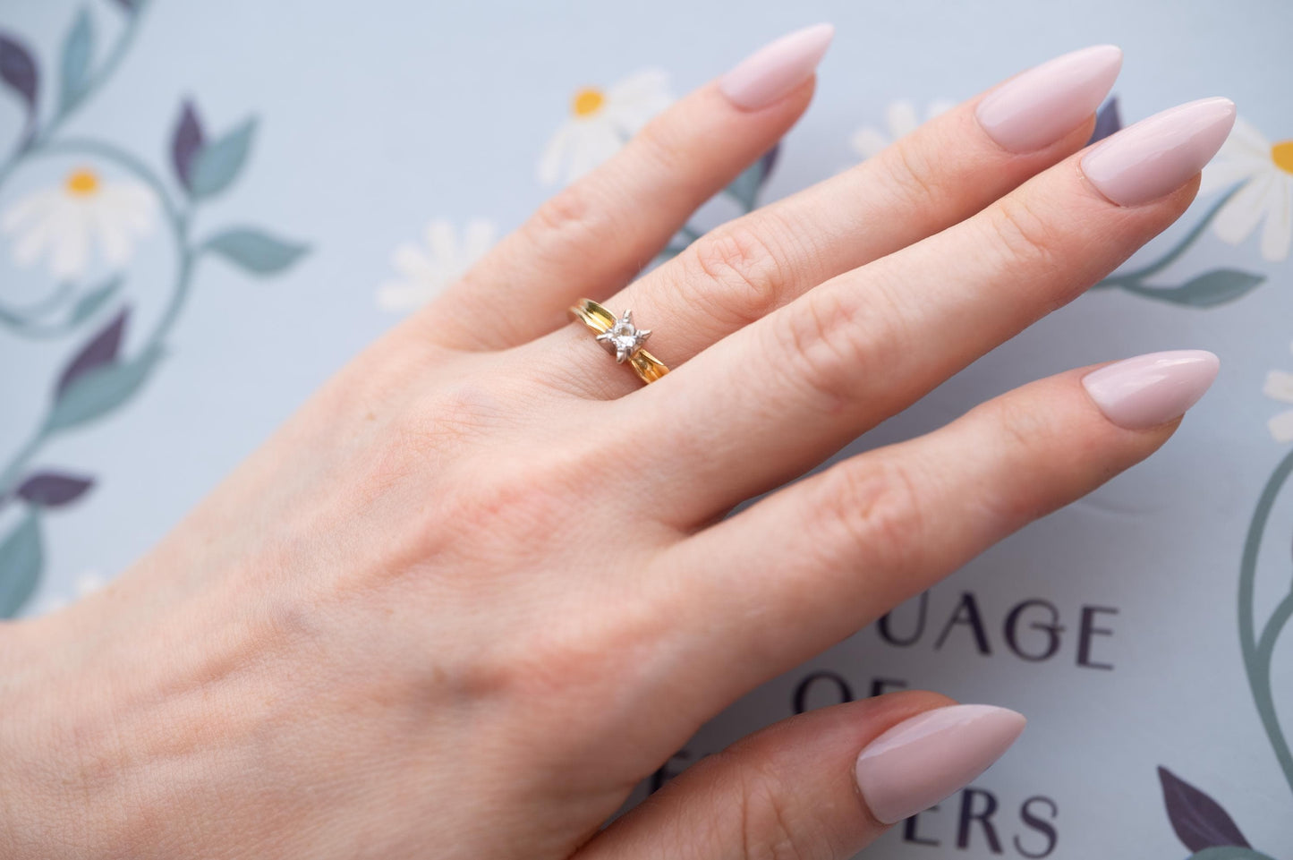 beautiful diamond ring shown on hand on engagement finger mid century 1960s diamond 18ct gold ring with art deco style
