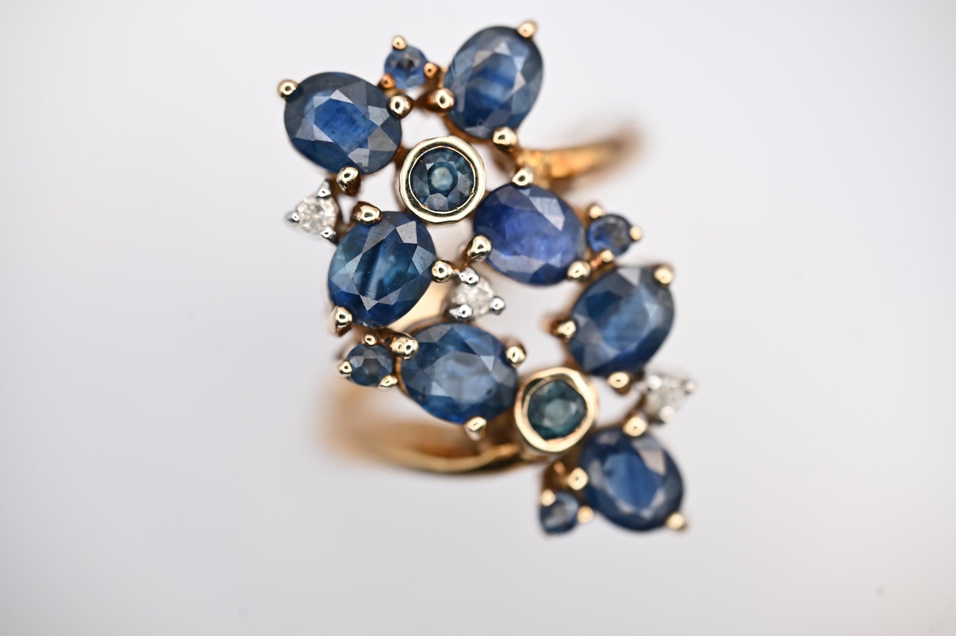 vintage glamorous sparkle ring in floral design inspired by art nouveau style - 9ct yellow gold brings out the blue from 11 sapphire stones