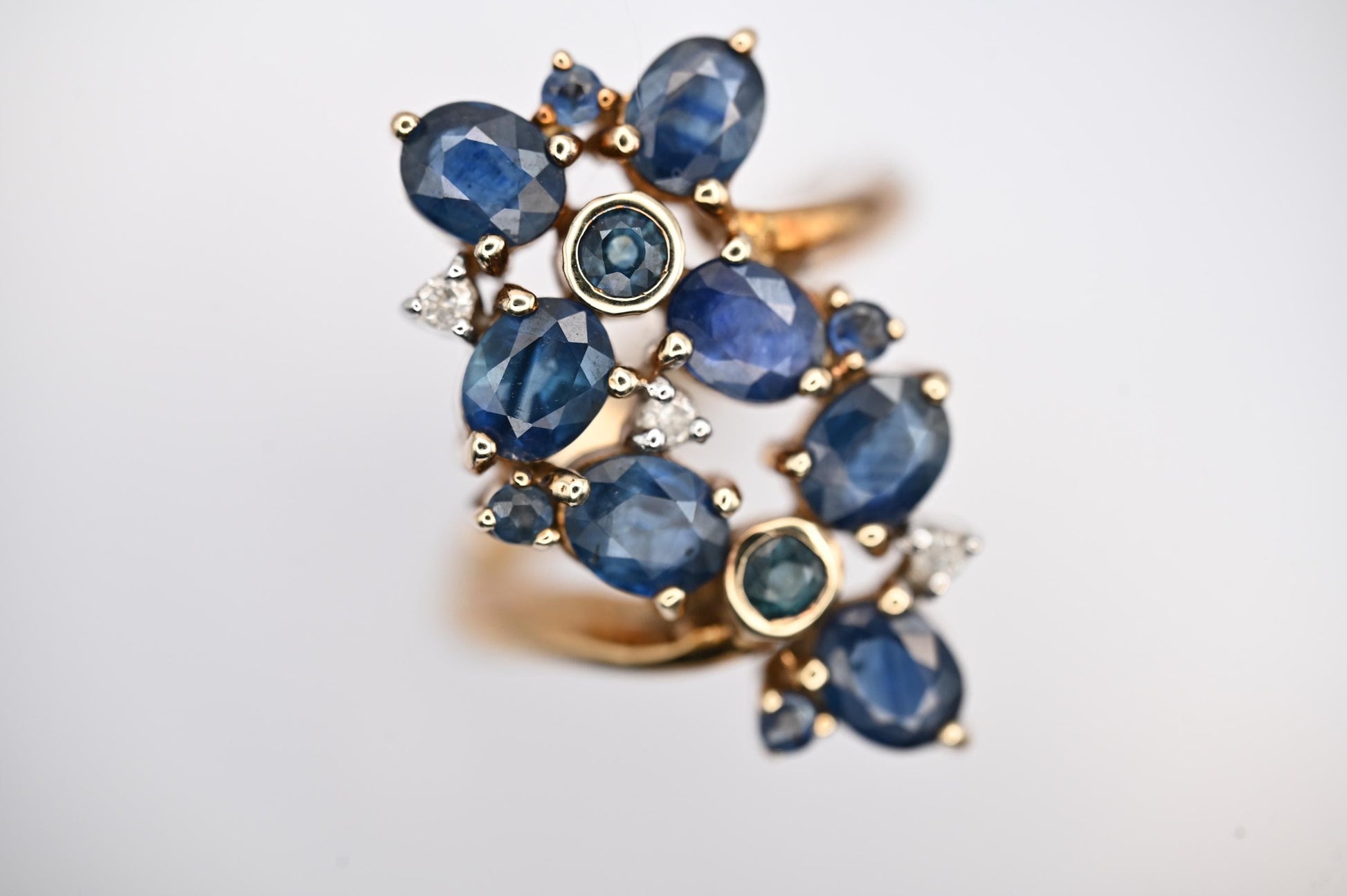 vintage glamorous sparkle ring in floral design inspired by art nouveau style - 9ct yellow gold brings out the blue from 11 sapphire stones