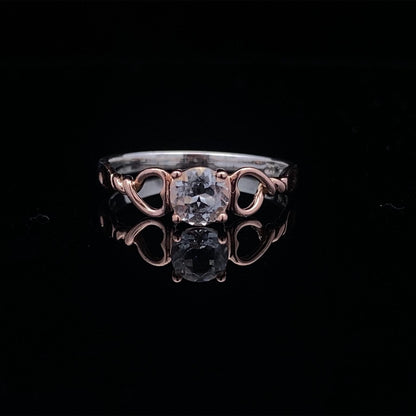 on black surface, ring shines beautifully showing the clear white topaz